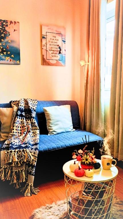 a living room with a blue couch and a table at The Lumiére Stays Sophisticated Escape Mallside Charm in Trece Martires