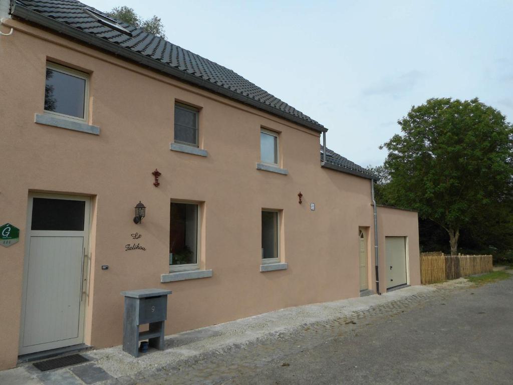 a building with two doors on the side of it at Gîte rural Le Falihou (3 épis) in Braives