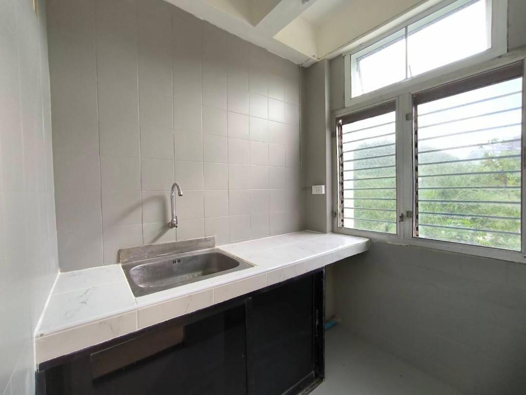 a kitchen with a sink and a window at Townhouse, 500m the Pink Line MRT, Near Airport 