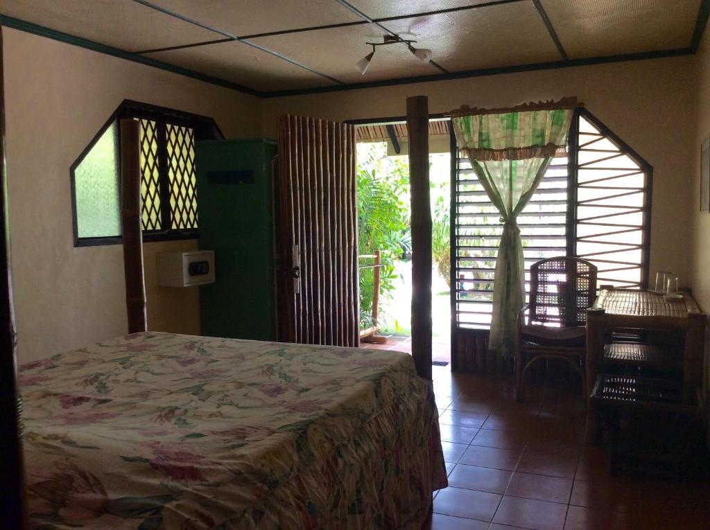 Postel nebo postele na pokoji v ubytování Ravenala Beach Bungalows