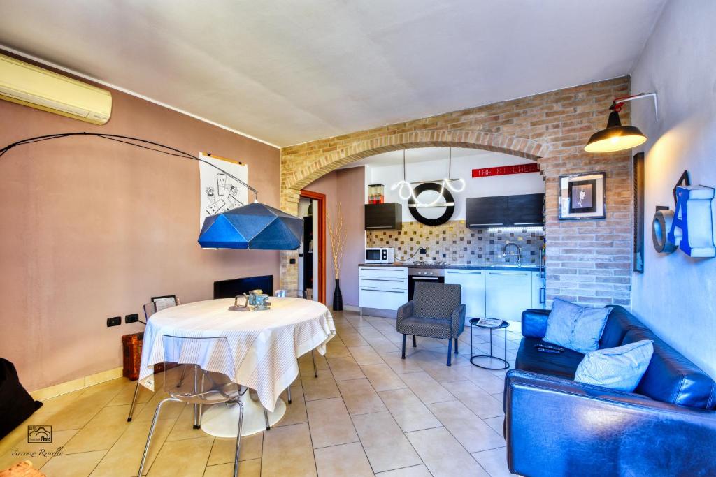 a living room with a table and a kitchen at InCorteDaFabio Design flat with Bikes in Caronno Pertusella