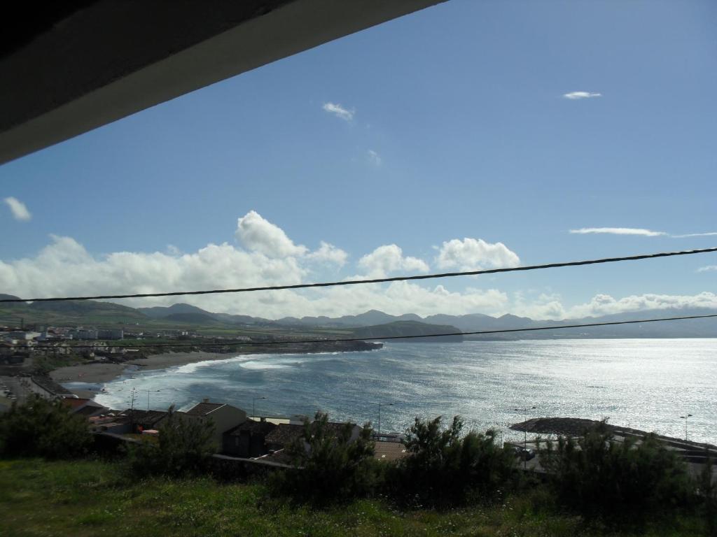 a view of a beach and the ocean at 106 Green North in Ribeira Grande