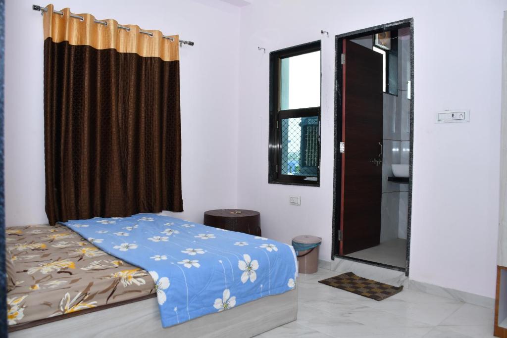 a bedroom with a bed and a window and a shower at Hotel Khatushyamji in Rīngas