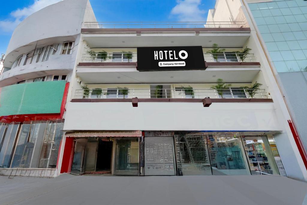 a hotel with a sign on the side of a building at Hotel O Khammam Railway Junction Formerly Raghavendra Inn in Khammam