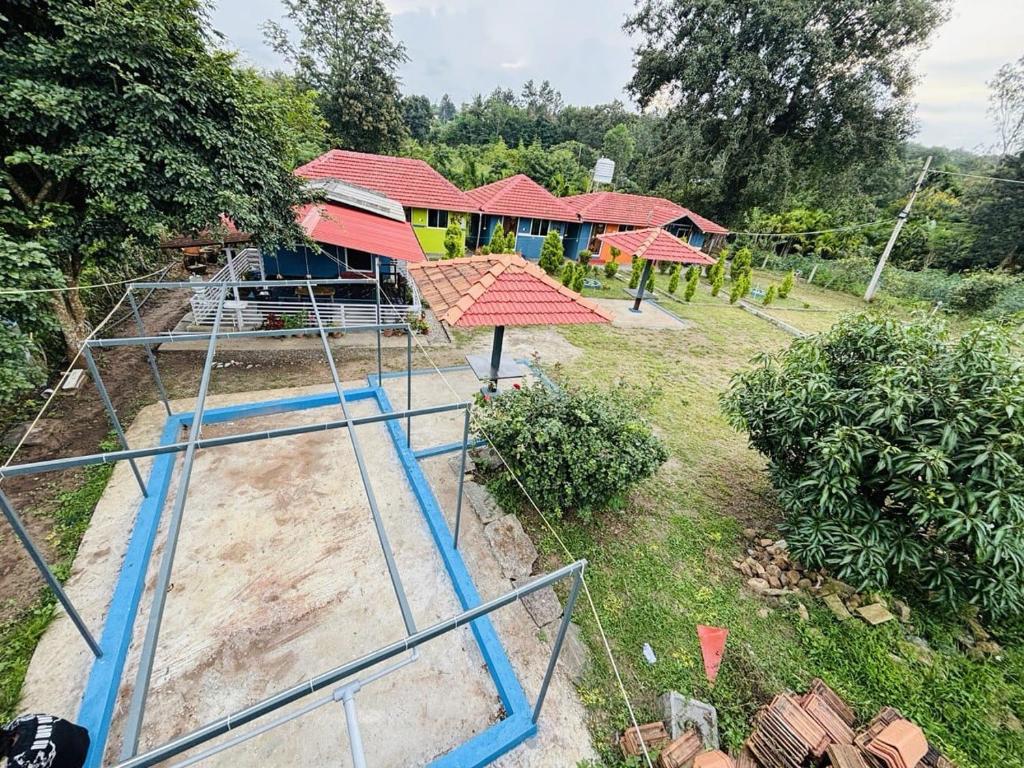 an aerial view of a house with a playground at Coorg Sunrise Cottage Homestay in Kushālnagar