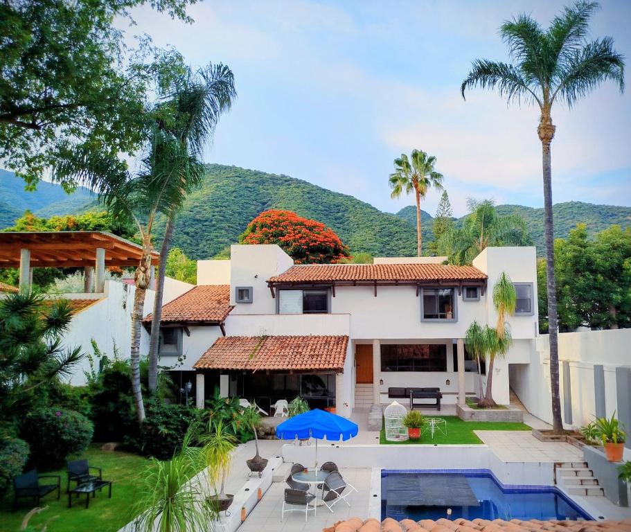 an aerial view of a house with a pool and palm trees at Beautiful Rooms at Villa La Floresta in Ajijic