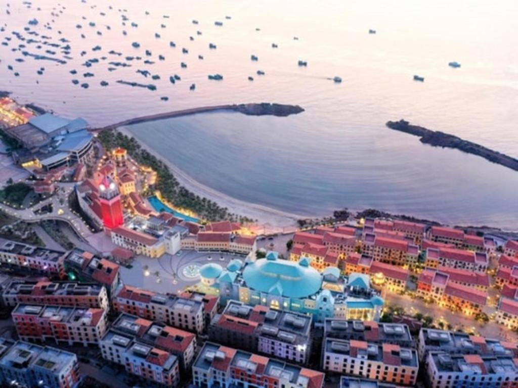 an aerial view of a beach with a flock of birds at Solara Apartment Firework & Sunset View in Phú Quốc