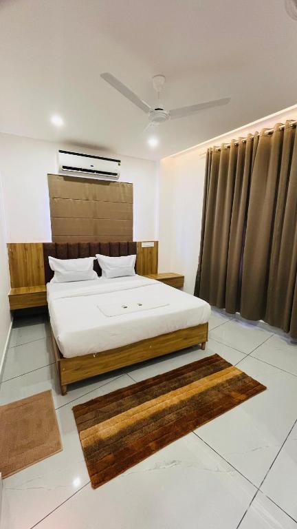 a bedroom with a bed in a room at LF Apartment in Kozhikode