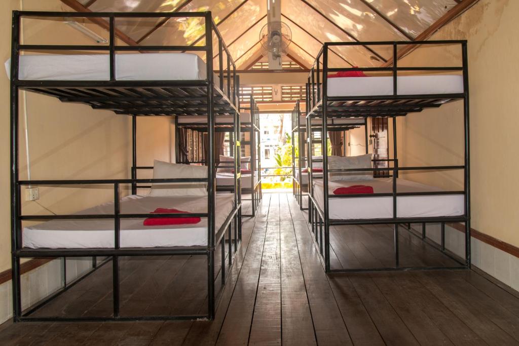 a room with a row of bunk beds at The Billabong Guesthouse in Kampot