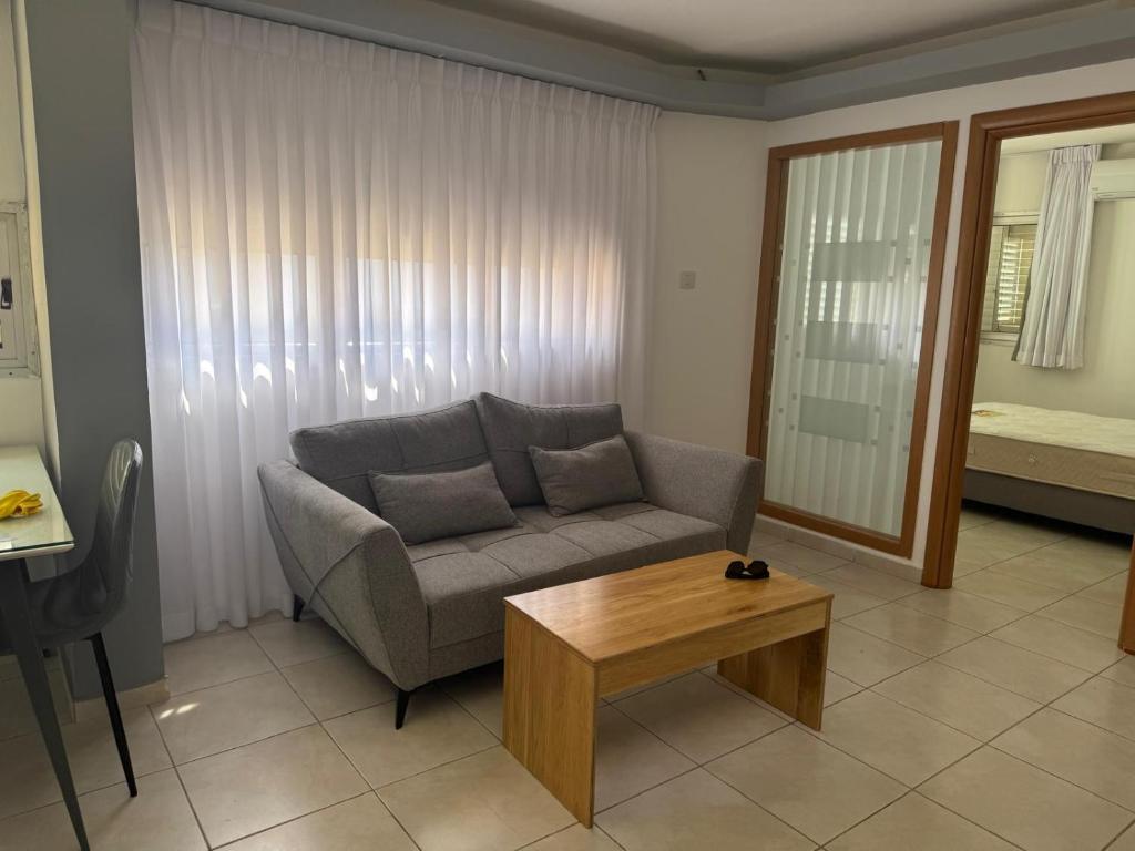 a living room with a couch and a coffee table at מגדלי חי 3 in Eilat
