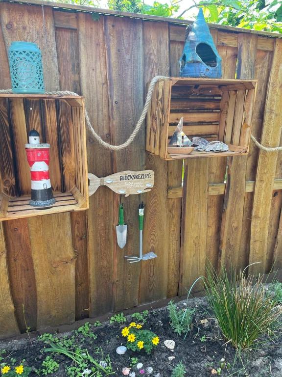 a wooden fence with two wooden boxes on it at Olivia in Rheinsberg