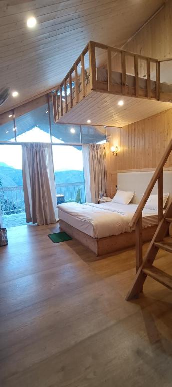a bedroom with a bunk bed and a staircase at Harshvan resort in Chakrāta