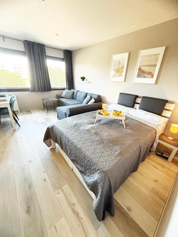 a bedroom with a large bed and a couch at Wohnung Bernstein in Burgtiefe auf Fehmarn 