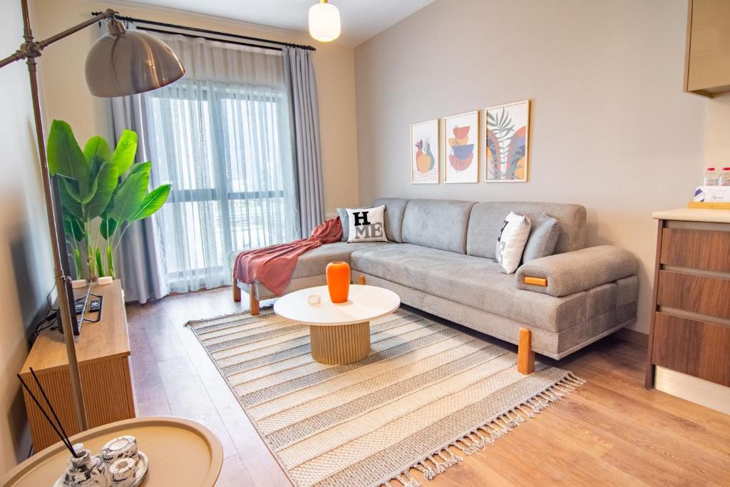 a living room with a couch and a table at Cozy Modern & Stylish 1br Apartment in Istanbul