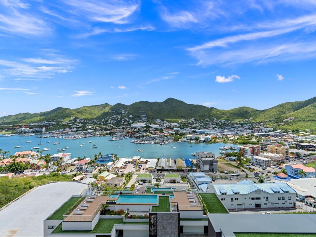 a view of a harbor with mountains in the background at The Hills Residence at Simpson Bay in Simpson Bay