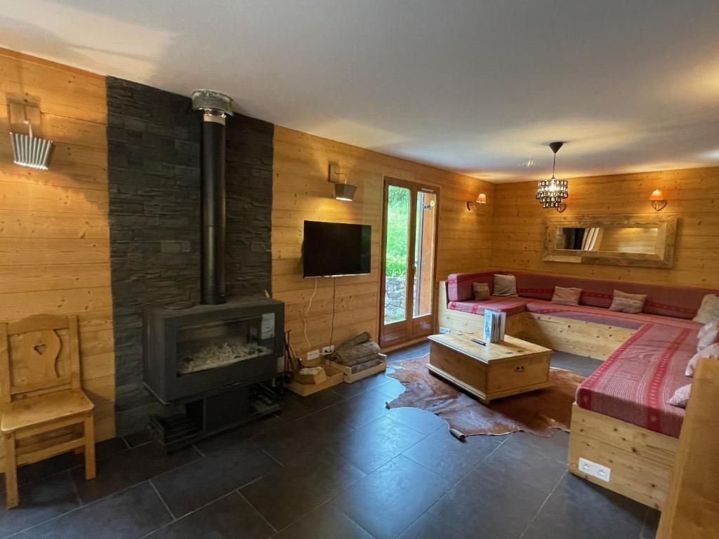 a living room with a couch and a fireplace at Chalet camp de base pour tribu sportif wifi 5 ch in Le Lioran