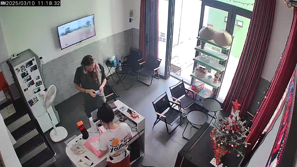 two people standing in a room with a table at Elegant Hostel Saigon - District 3 in Ho Chi Minh City