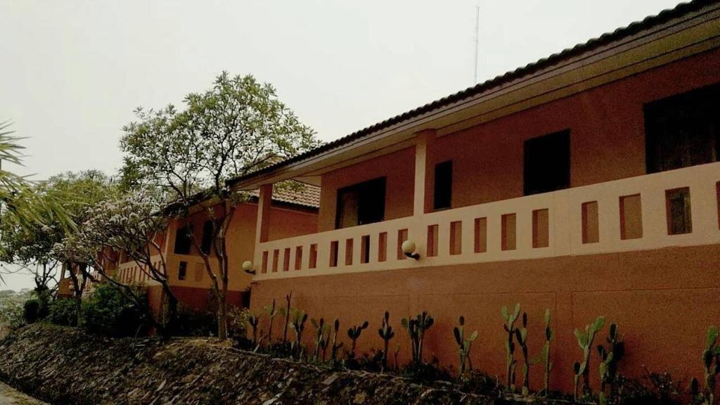 a red brick building with cactuses on the side of it at Rimpuhill resort in Sattahip