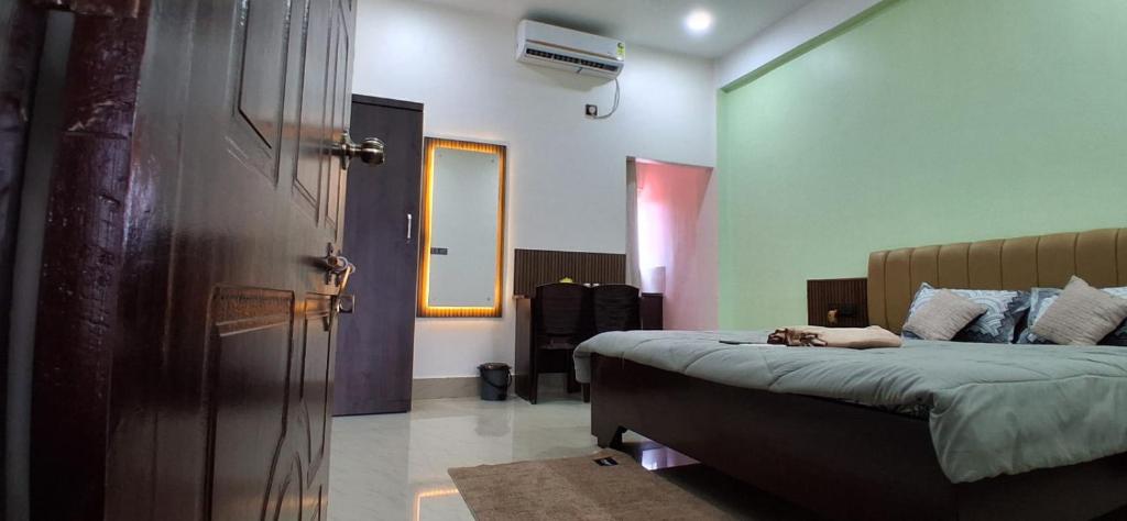 a bedroom with a bed with a dog laying on it at Regal homes in Tezpur