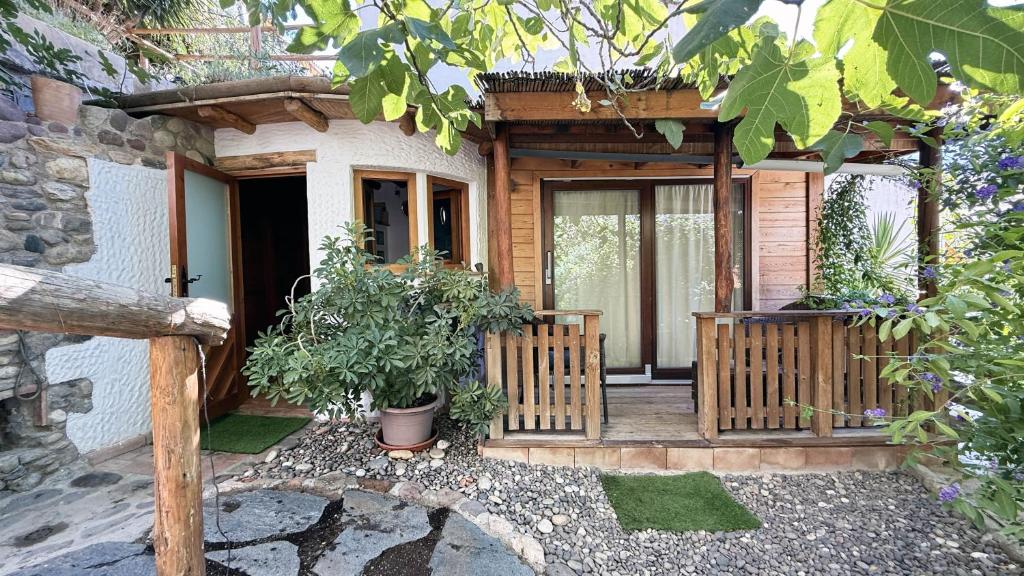 a house with a wooden porch with potted plants at Mshome La Turquesa in Monachil