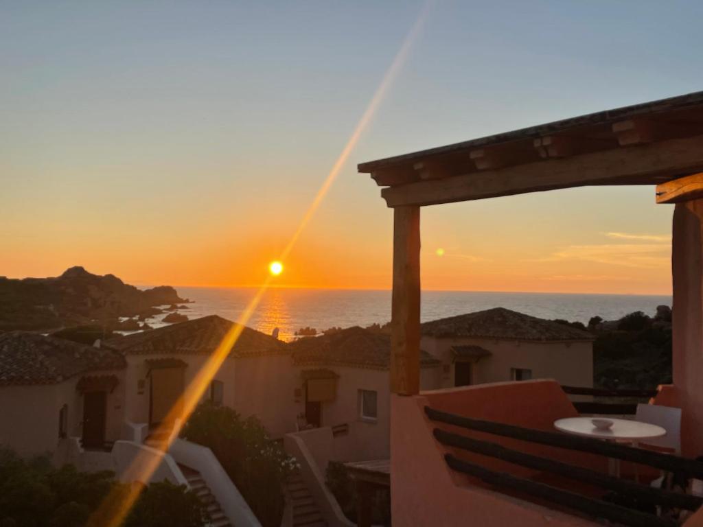 a sunset from the balcony of a house at Splendida vista mozzafiato Costa Rossa Sardegna in Isola Rossa