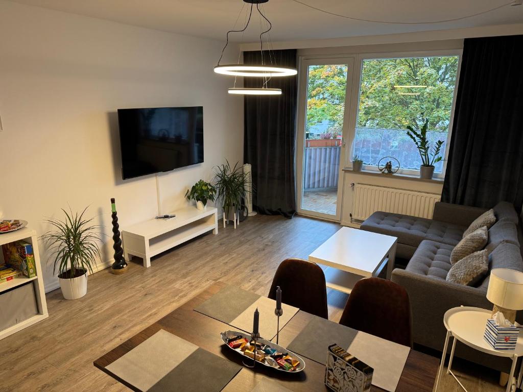 a living room with a couch and a table at Emilys 3 Room Apartment 70 qm in Hannover