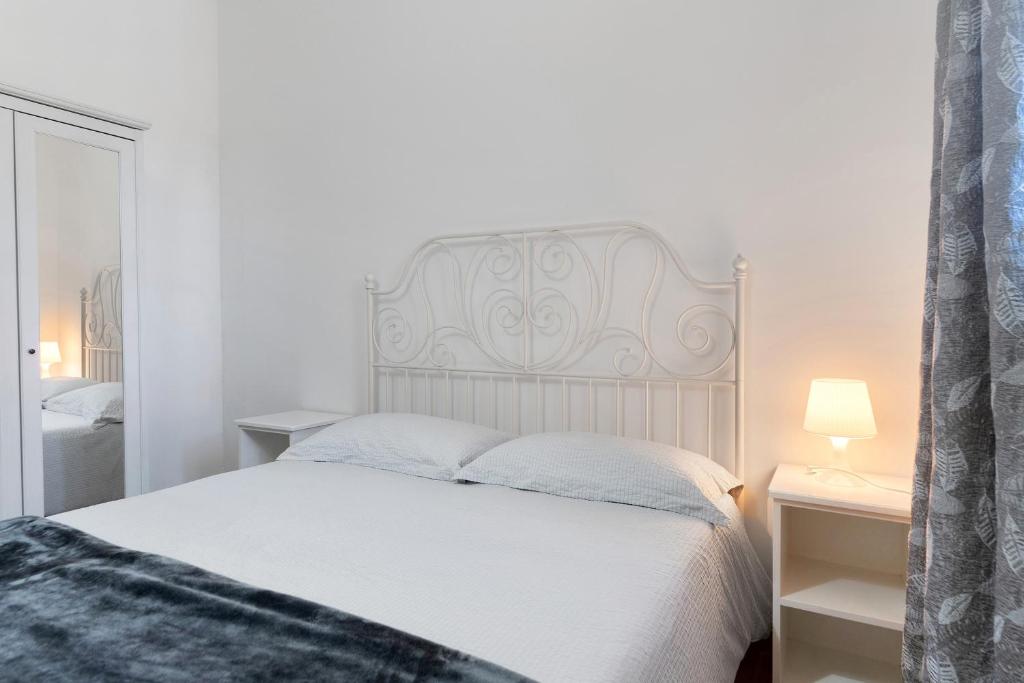 1 dormitorio con cama blanca y cabecero blanco en Ride Home 2, en Commezzadura