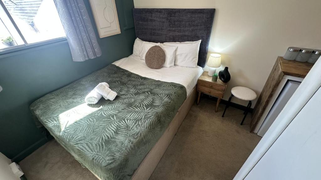 a small bedroom with a bed with a teddy bear on it at 1 Double Bedroom-Shared House-Stonehouse-Stroud-Room 3 in Stonehouse