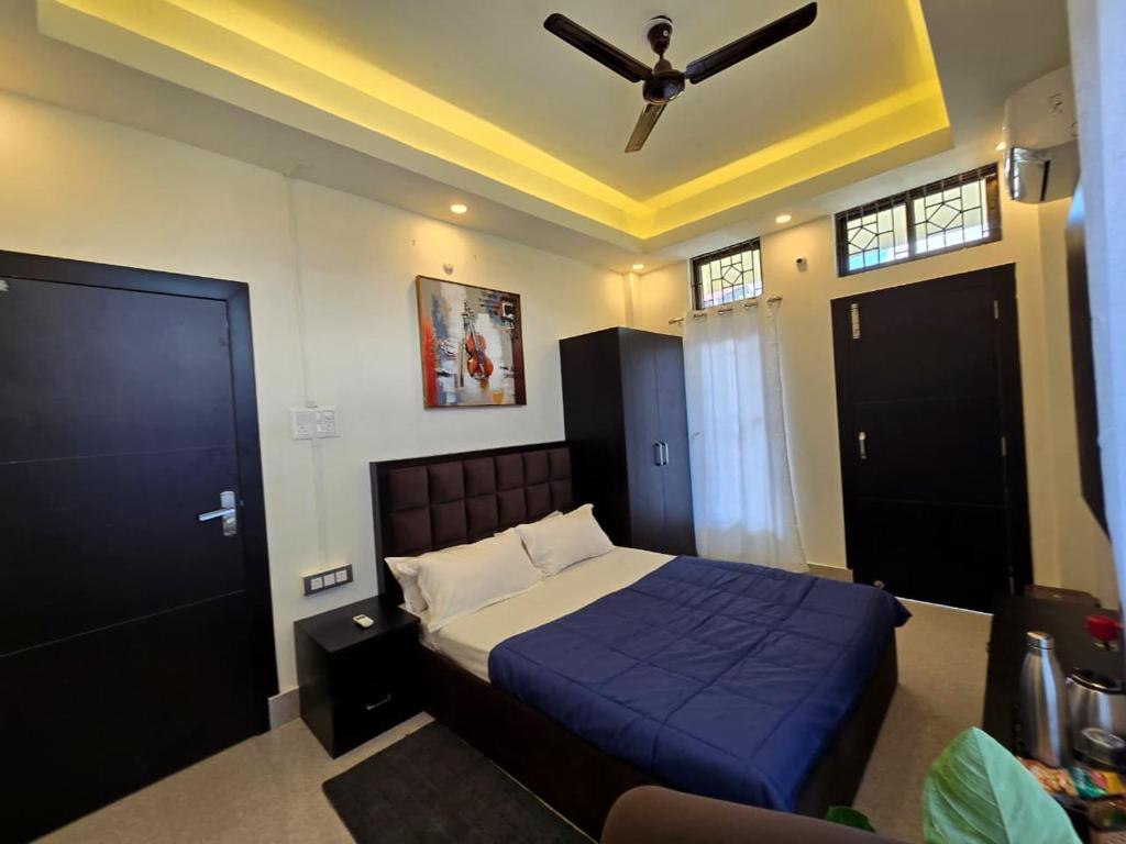 a bedroom with a bed and a ceiling fan at Lir-etso Homestay in Diphu