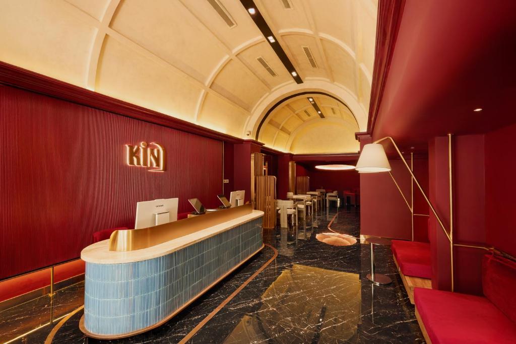 a waiting room with red walls and a large tub at Kin Hotel Onsen Edition in Ho Chi Minh City