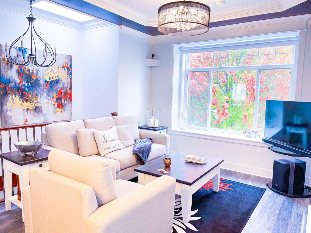 a living room with a couch and a tv at Spacious Family Home in Vancouver in Vancouver