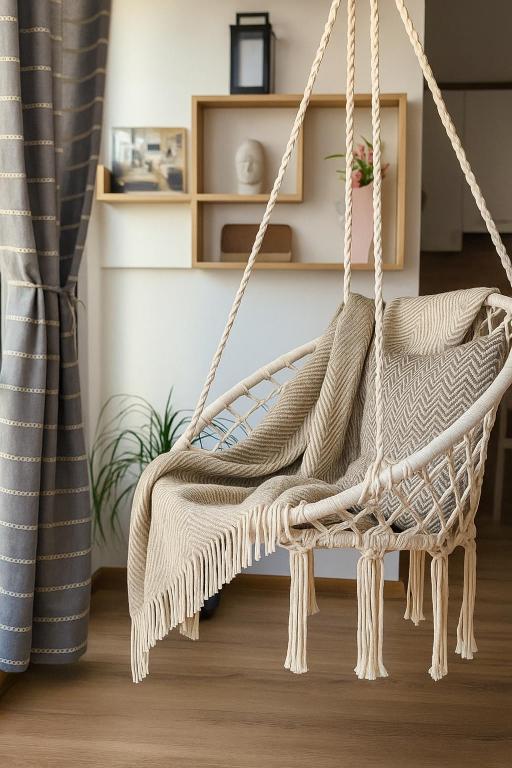 a rattan swing in a living room with at Studio Apartment City Dream in Stara Zagora