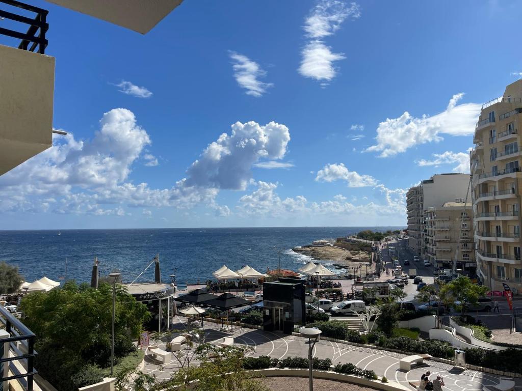 a view of the ocean from a building at Brand New Seafront Apartment in Sliema