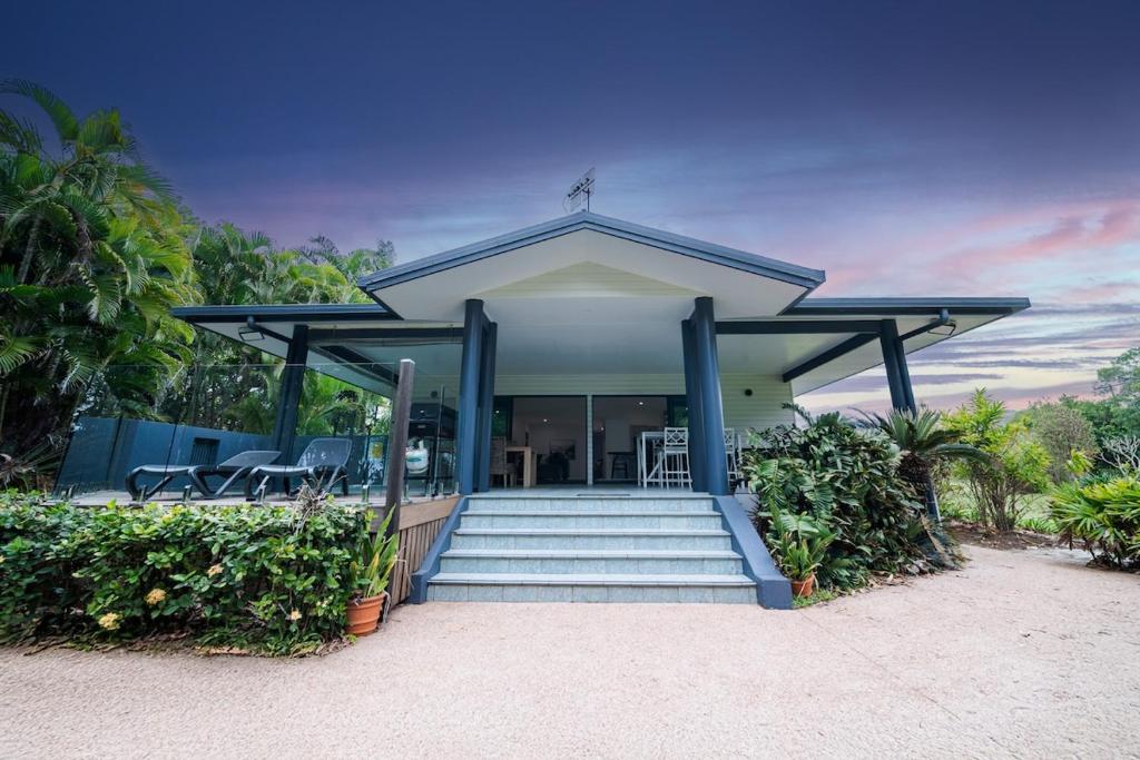 a house with a staircase leading up to a porch at Beachside on Pacific in Mission Beach
