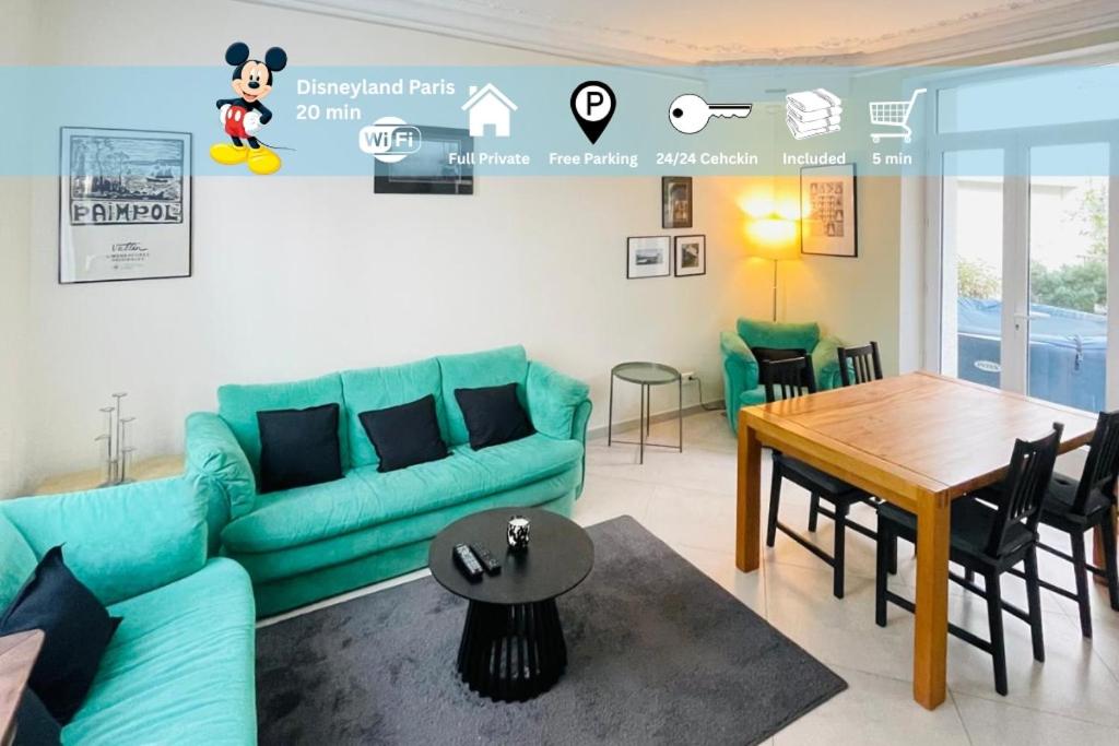 a living room with a blue couch and a table at Noisy Home - 10 pers - Paris in Noisy-le-Grand