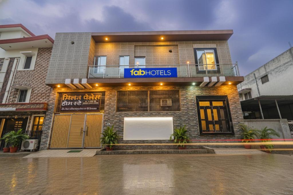a building with a white sign on the front of it at FabExpress Milan Palace in Ayodhya
