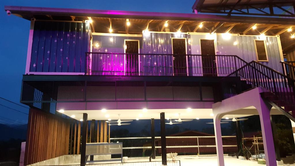 a house with purple lights on the side of it at A105 Homestay in Sungkai