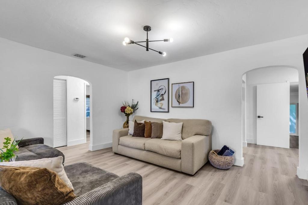 a living room with a couch and a ceiling fan at Luxury Miami Home Next to Wynwood & Downtown in Miami