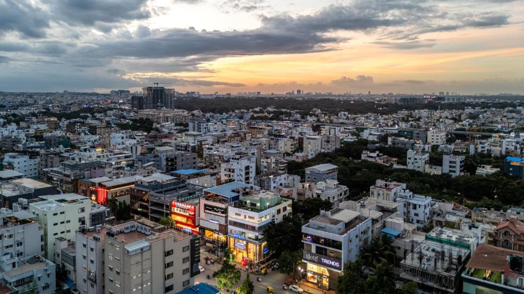 an aerial view of a city at sunset at HSR Penthouse Spacious 4-BHK Apartment with Living, Lounge Area, Study Room, Terrace & Balconies in Bengaluru