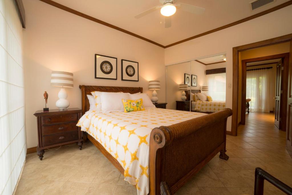 a bedroom with a bed and a desk and a lamp at Veranda 8F 2 bdr Garden View in Los Suenos in Herradura