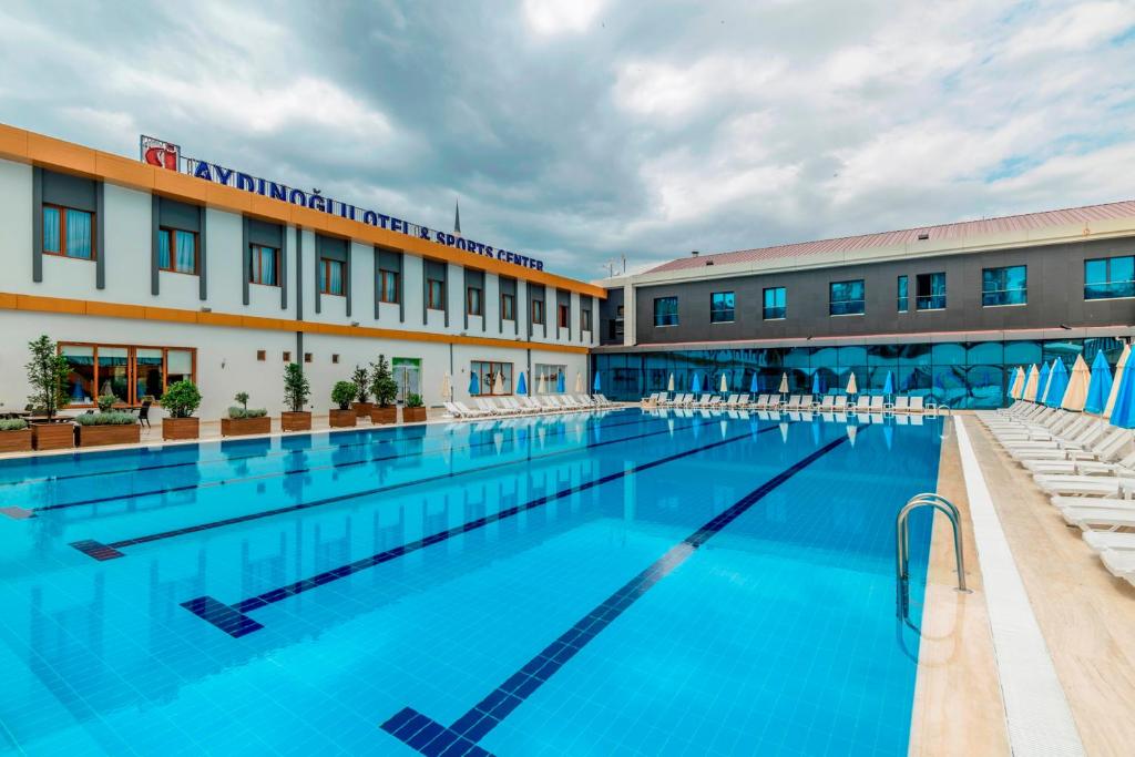 a large swimming pool in front of a building at Aydinoglu Hotel in Istanbul