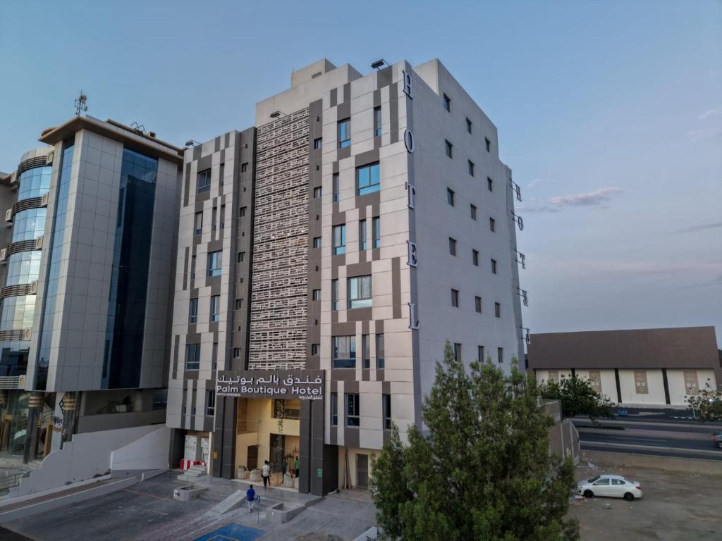 a tall building with a street sign in front of it at بالم بوتيك النهضة in Jeddah