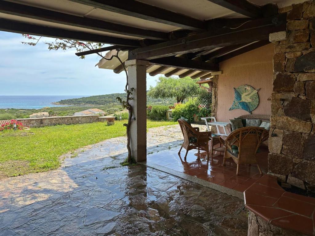 a patio of a house with a table and chairs at Villa Germana in Porto Ottiolu