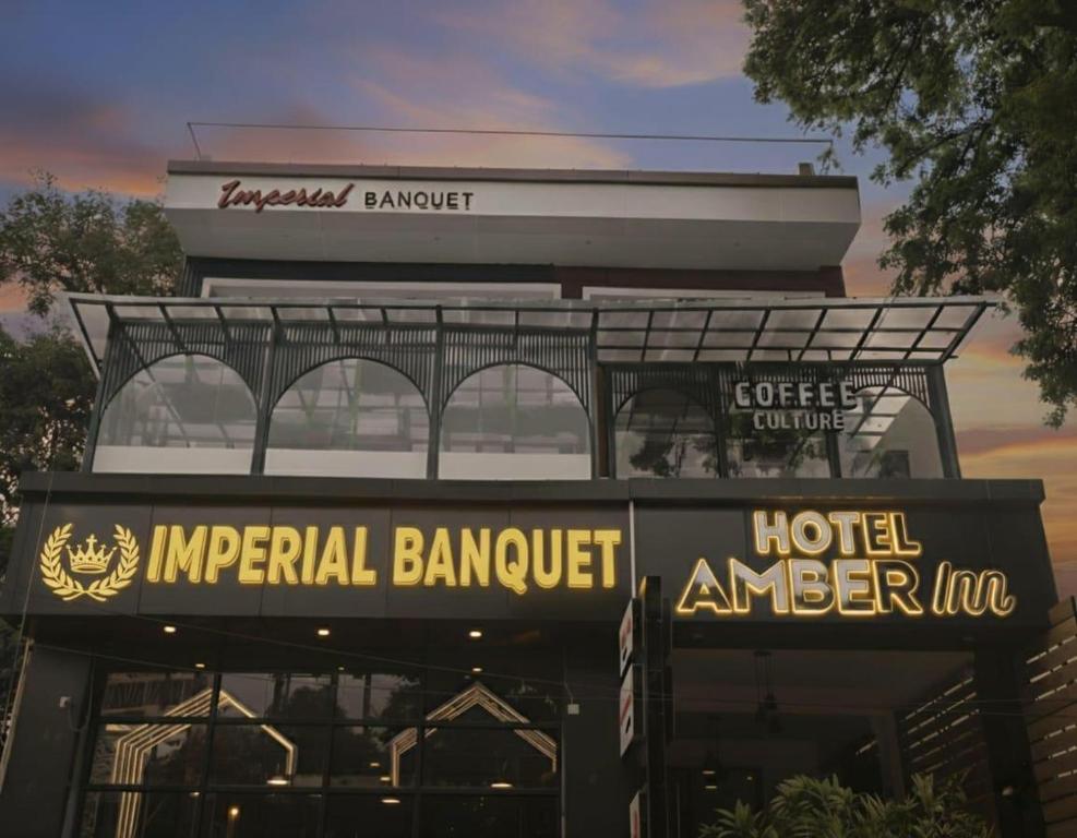 a hotel sign in front of a building at Hotel Amber Inn in Prayagraj