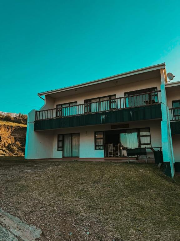 an apartment building with a balcony and a bench at Sea View in Coffee Bay