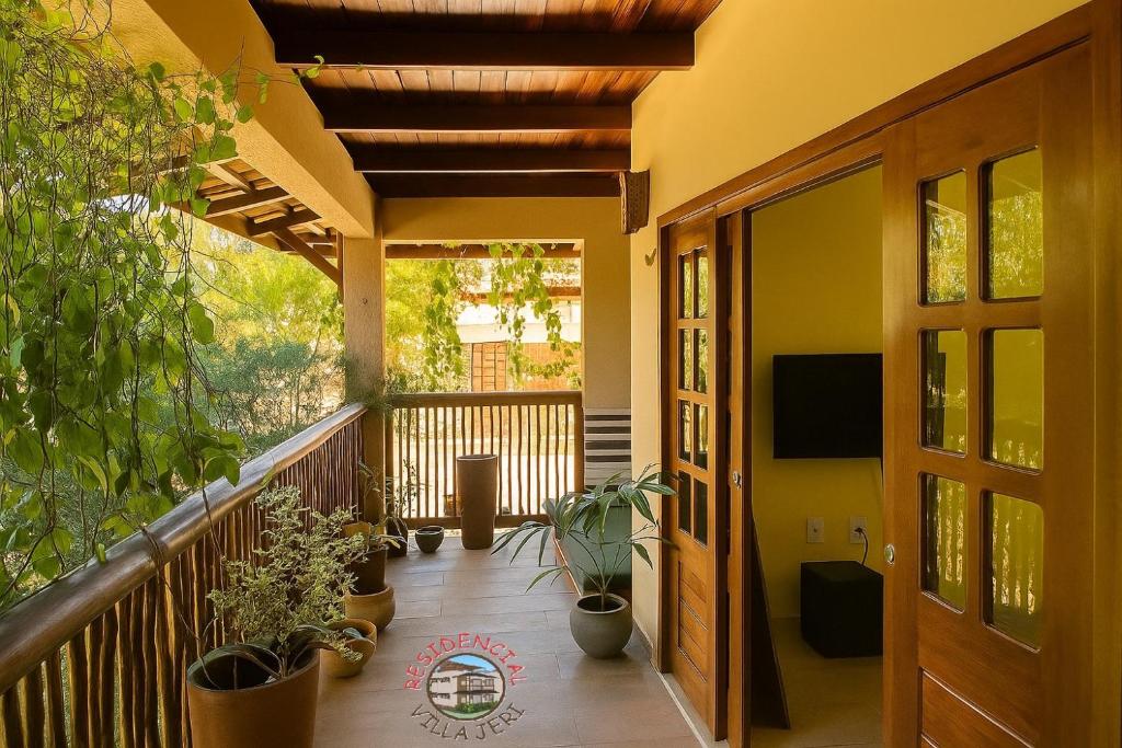 a balcony with potted plants and a television at Residencial Villa Jeri - AP with balcony, optional BREAKFAST in Jericoacoara