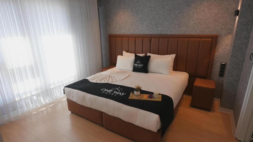 a bedroom with a large bed with a wooden headboard at One way in Kayseri
