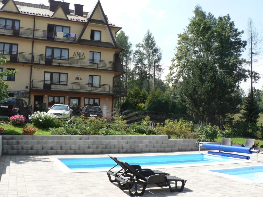 a pool in front of a large building at Ośrodek Wypoczynkowy Ania in Rabka-Zdrój