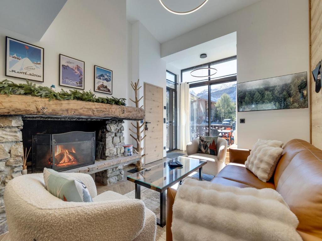 a living room with couches and a fireplace at Chalet rénové 10 personnes à Tignes, sauna inclus - FR-1-641-121 in Tignes