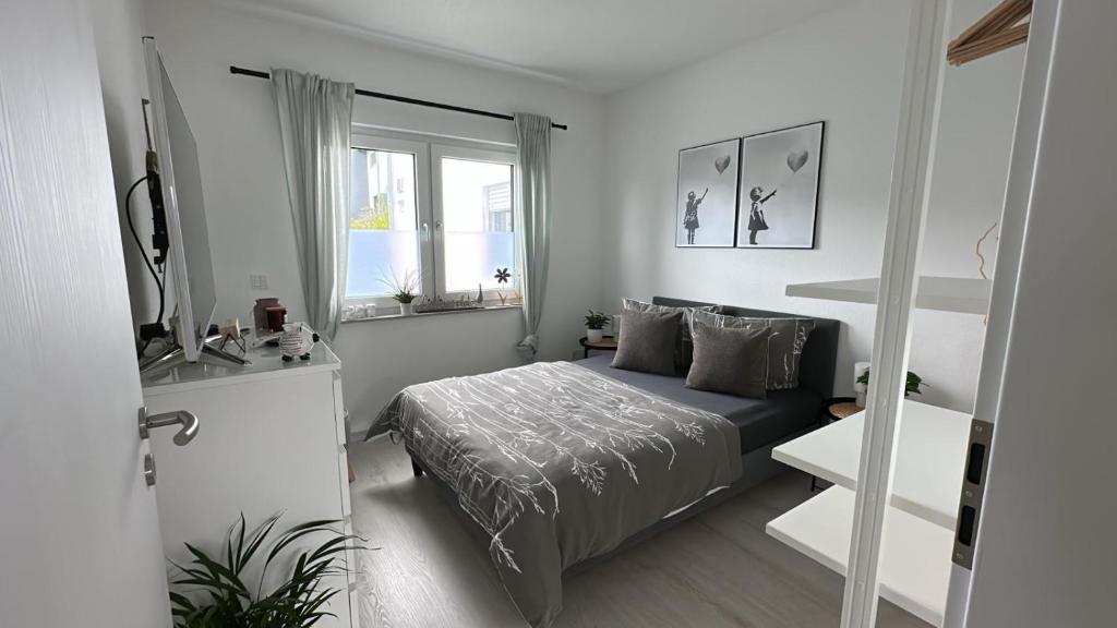 a small bedroom with a bed and a window at FeWo S26 in Krumbach